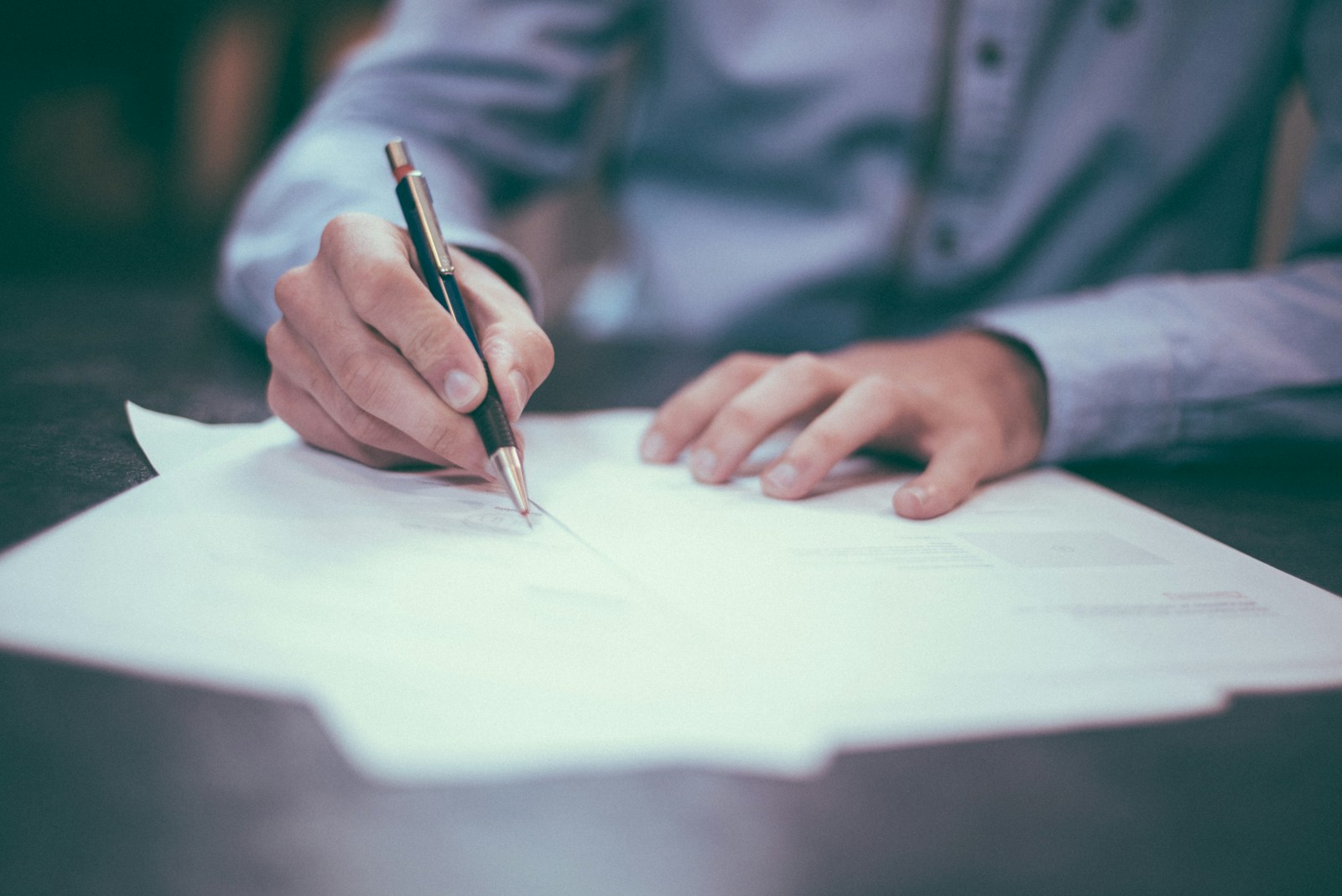 Contract desk with marked-up software agreement clauses under litigation review